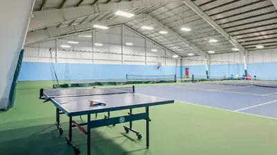 a tennis court with a table in the middle of it at Slopeside Escape by AvantStay Walk to Ski Lifts Arcade Games Shuffleboard in Tannersville