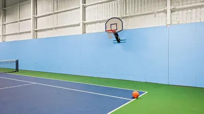a basketball hoop sitting on a tennis court at Slopeside Escape by AvantStay Walk to Ski Lifts Arcade Games Shuffleboard in Tannersville