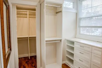 a walk in closet with white cabinets and a window at 7BR Spacious Property Perfect For up to 15! in Orange