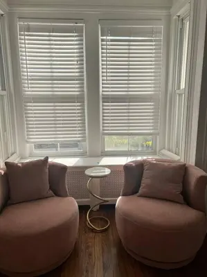a living room with two chairs and two windows at 7BR Spacious Property Perfect For up to 15! in Orange