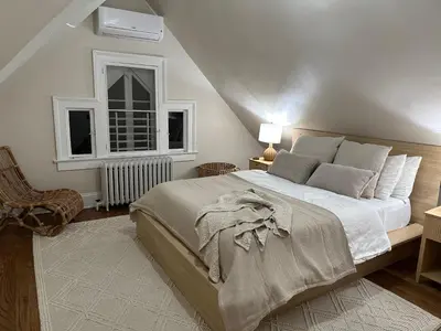 a bedroom with a large bed and a window at 7BR Spacious Property Perfect For up to 15! in Orange