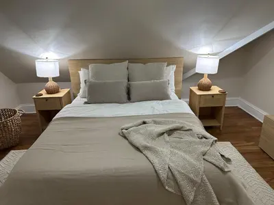a bedroom with a bed with two lamps on both sides at 7BR Spacious Property Perfect For up to 15! in Orange