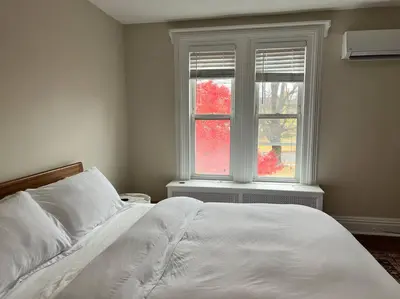 a bedroom with a white bed and a window at 7BR Spacious Property Perfect For up to 15! in Orange