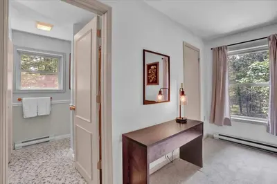a home office with a desk and two windows at Chalet Lake, Movie Theater, Hot Tub, Arcade in Gouldsboro