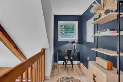 a blue room with a table and a chair at Chalet Lake, Movie Theater, Hot Tub, Arcade in Gouldsboro