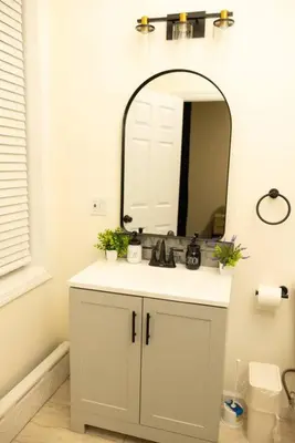 a bathroom with a sink and a mirror at Paloma - Lux Industrial Townhome in Newark