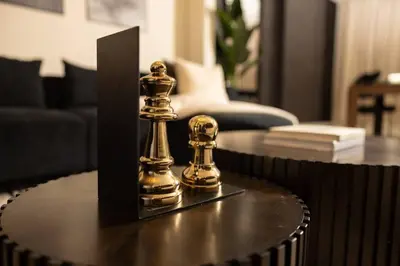 two gold chess pieces sitting on top of a table at Paloma - Lux Industrial Townhome in Newark
