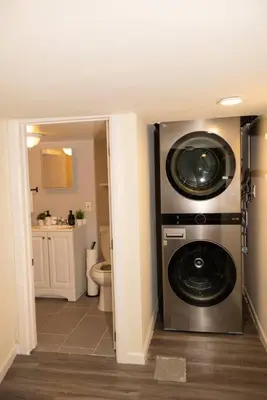 a bathroom with a washer and dryer in a room at Paloma - Lux Industrial Townhome in Newark