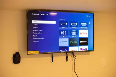 a flat screen tv hanging on a wall at Paloma - Lux Industrial Townhome in Newark
