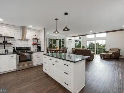 a large kitchen with white cabinets and a living room at Pocono Mountains Village at Camelback 284 Overlook Way in Tannersville