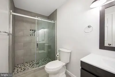 a bathroom with a toilet and a glass shower at Pocono Mountains Village at Camelback 284 Overlook Way in Tannersville