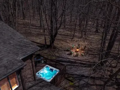 an overhead view of a swimming pool in the woods at Winter Hideaway - Sled Hill, Hot Tub, Fireplace, Game Room in Gouldsboro
