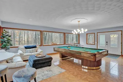 a living room with a pool table in it at Winter Hideaway - Sled Hill, Hot Tub, Fireplace, Game Room in Gouldsboro