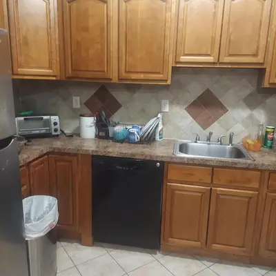 a kitchen with a sink and a dishwasher at Deluxe Room E in Jersey City