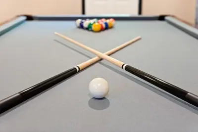 two cue sticks and a ball on a pool table at Love Lace Retreat in Albrightsville