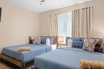 two beds in a bedroom with blue and white at Love Lace Retreat in Albrightsville
