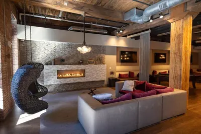 a living room with a couch and a fireplace at The Othello - Luxury Industrial Loft near NYC in Communipaw