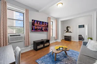 a living room with a couch and a table at Hoboken 15 Min Train to Manhattan Full Kitchen in Hoboken