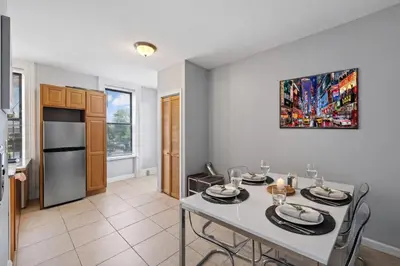 a kitchen and dining room with a table and chairs at Hoboken 15 Min Train to Manhattan Full Kitchen in Hoboken