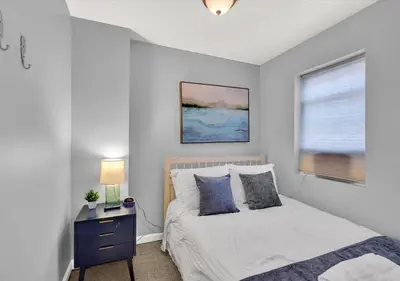 a bedroom with a bed and a window at 2 Miles From Rocky Statue in Philadelphia