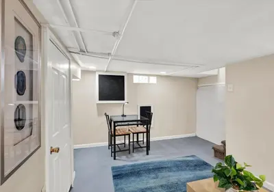 a dining room with a table and a tv at 2 Miles From Rocky Statue in Philadelphia