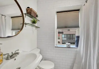 a bathroom with a sink and a toilet and a mirror at 2 Miles From Rocky Statue in Philadelphia