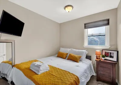 a bedroom with a bed and a flat screen tv at 2 Miles From Rocky Statue in Philadelphia