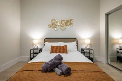 a bedroom with a bed with two towels on it at Modern Loft 15 Min from NYC with City View & Pool in Croxton