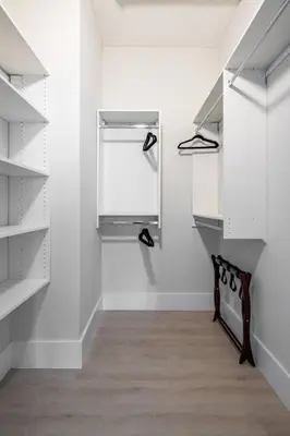 a room with white shelves and shoes on the wall at Modern Loft 15 Min from NYC with City View & Pool in Croxton