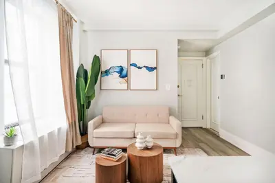 a living room with a couch and a table at 73-508 New 1BR 1Bth UWS Doorman Gym in New York