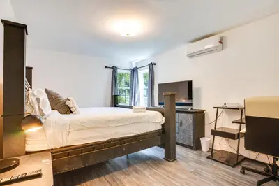 a bedroom with a bed and a desk and a tv at 4 Mi to NYC, Shared Yard Englewood Apartment! in Englewood