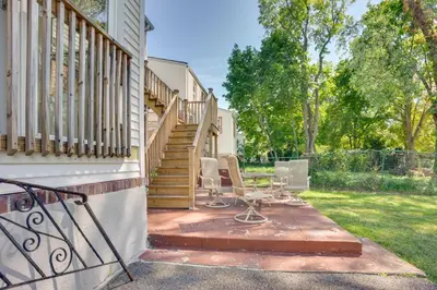a patio with two chairs and a stair case at 4 Mi to NYC, Shared Yard Englewood Apartment! in Englewood