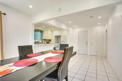 a dining room with a table and a kitchen at 4 Mi to NYC, Shared Yard Englewood Apartment! in Englewood
