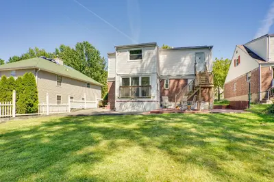 a large yard with a house and a building at Shared Yard, 4 Mi to NYC Englewood Apartment! in Englewood