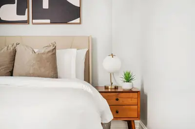 a bedroom with a bed and a nightstand with a lamp at 73-1406 New 1BR 1Bth UWS Doorman Gym in New York
