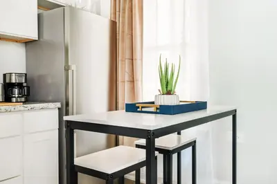 a table in a kitchen with a plant on it at 73-1406 New 1BR 1Bth UWS Doorman Gym in New York