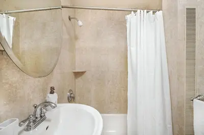 a bathroom with a sink and a shower curtain at 73-1406 New 1BR 1Bth UWS Doorman Gym in New York