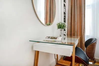 a desk with a mirror and a glass table at 444-1A Beautiful 1BR Midtown West in New York