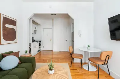 a living room with a couch and a table at 444-1A Beautiful 1BR Midtown West in New York