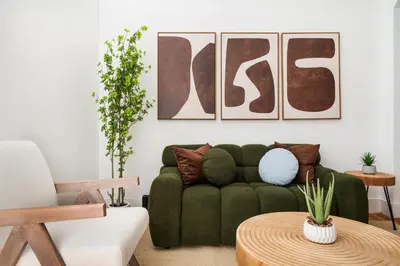 a living room with a green couch and a table at 444-1A Beautiful 1BR Midtown West in New York