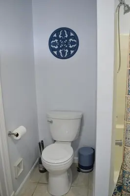 a bathroom with a toilet and a plate on the wall at Spacious 2BD near Princeton, Cafes! Family, Backyard, Parking