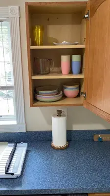 a cupboard with plates and bowls in a kitchen at Spacious 2BD near Princeton, Cafes! Family, Backyard, Parking