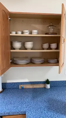 a cupboard with plates and dishes in it at Spacious 2BD near Princeton, Cafes! Family, Backyard, Parking