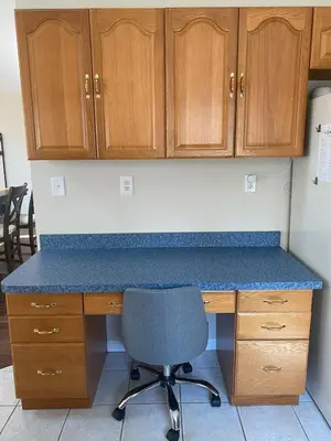 a desk with a chair and wooden cabinets at Spacious 2BD near Princeton, Cafes! Family, Backyard, Parking
