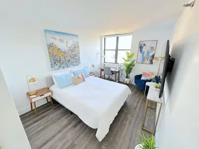 a bedroom with a white bed and a desk at Luxury 2BR - Elevator-Gym-Laundry-10 Min to NYC in Hoboken