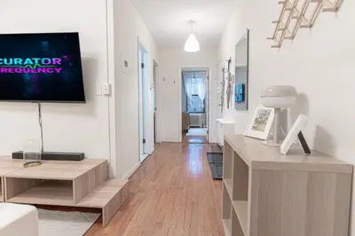 a living room with a flat screen tv on a wall at Chic 3Bd 1Bth Near Empire State in New York