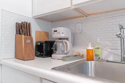 a kitchen counter with a sink next to a kitchen counter sidx sidx sidx at Chic 3Bd 1Bth Near Empire State in New York