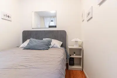 a bedroom with a bed and a mirror on the wall at Chic 3Bd 1Bth Near Empire State in New York