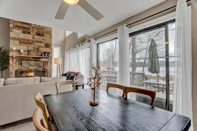 a living room with a wooden table and chairs at Pet Friendly! Lakefront w Hot Tub, Firepit! in Tobyhanna