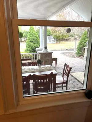 a view of a table and chairs through a window at THE VILLA Farm Sleeps 20 more in Montgomery